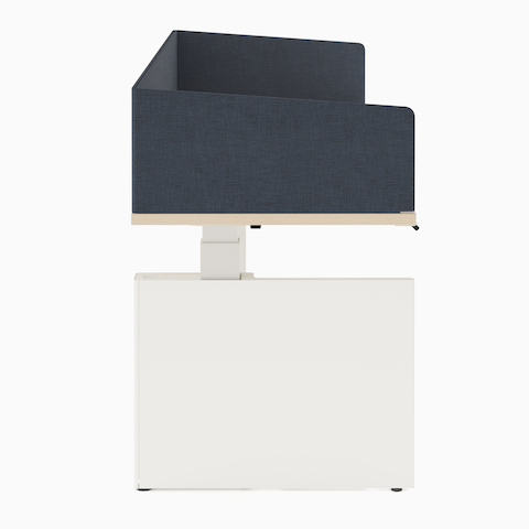 Height adjustable desk with white table shroud hiding underneath the table, and navy fabric privacy screen hiding the worksurface.