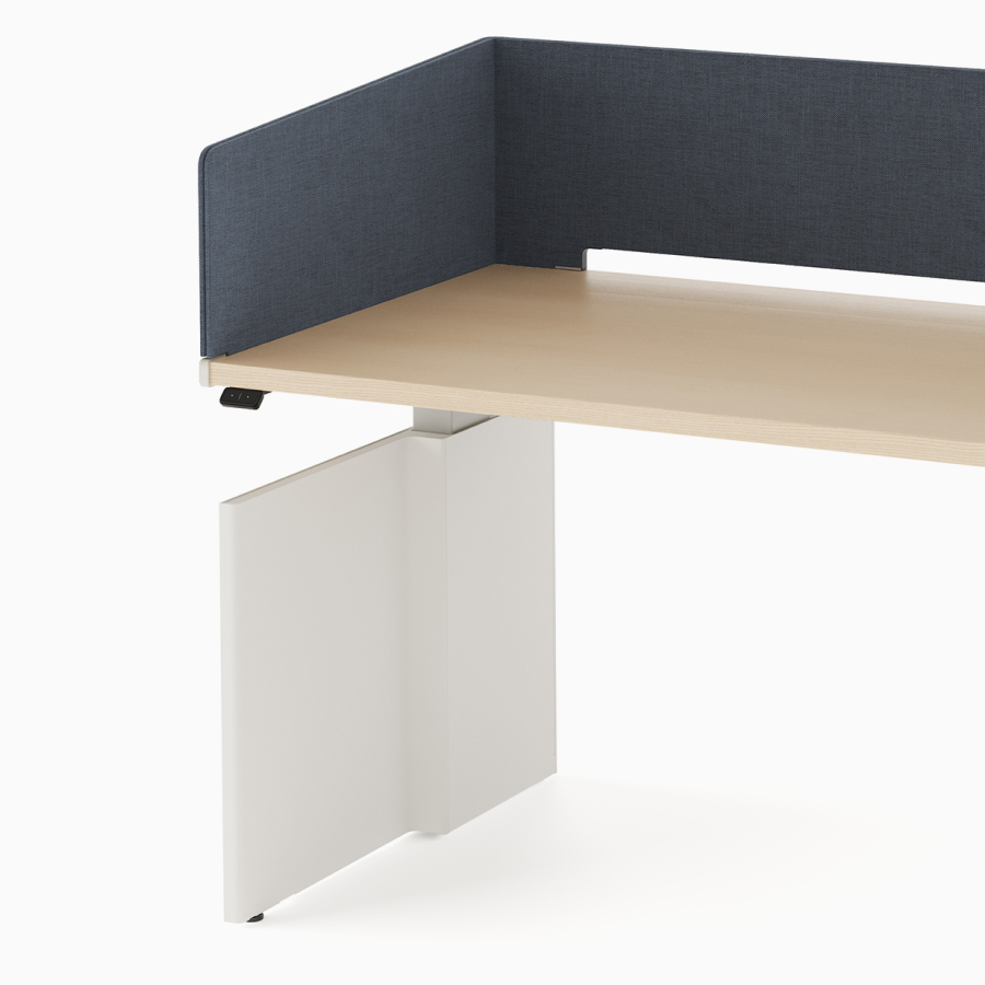 Open, navy metal storage attached to laminate surface of desk with navy fabric wrapped screen.