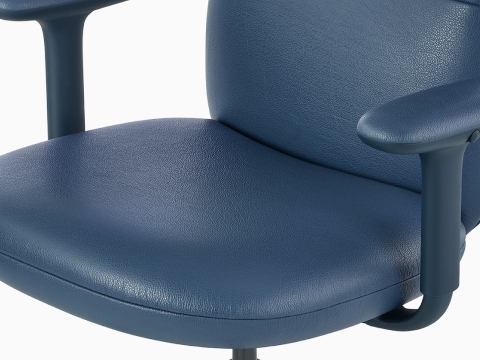 Top angle view of a mid-back Asari chair in dark blue with height adjustable arms. Top angle view of a mid-back Asari chair in dark blue with height adjustable arms.