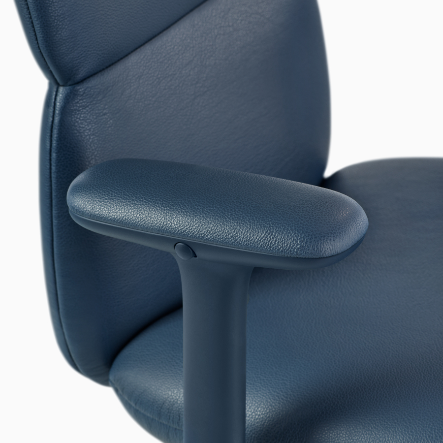 Detail view of an Asari chair by Herman Miller in dark blue leather with height adjustable arms