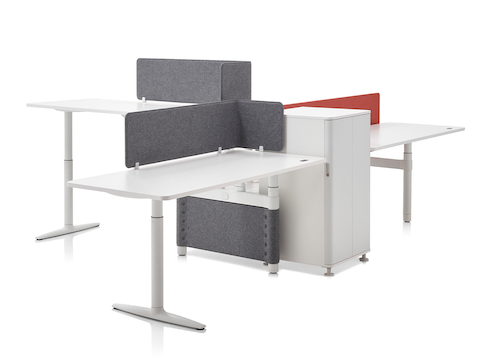 A collaboration cluster of three height-adjustable Atlas Office Landscape desks with gray privacy screens. A collaboration cluster of three height-adjustable Atlas Office Landscape desks with gray privacy screens.