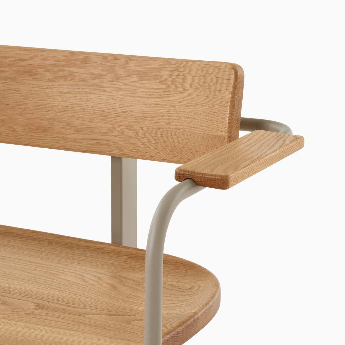 A close-up of a Betwixt Bench with oak seat, backrest and arms, with a grey frame.