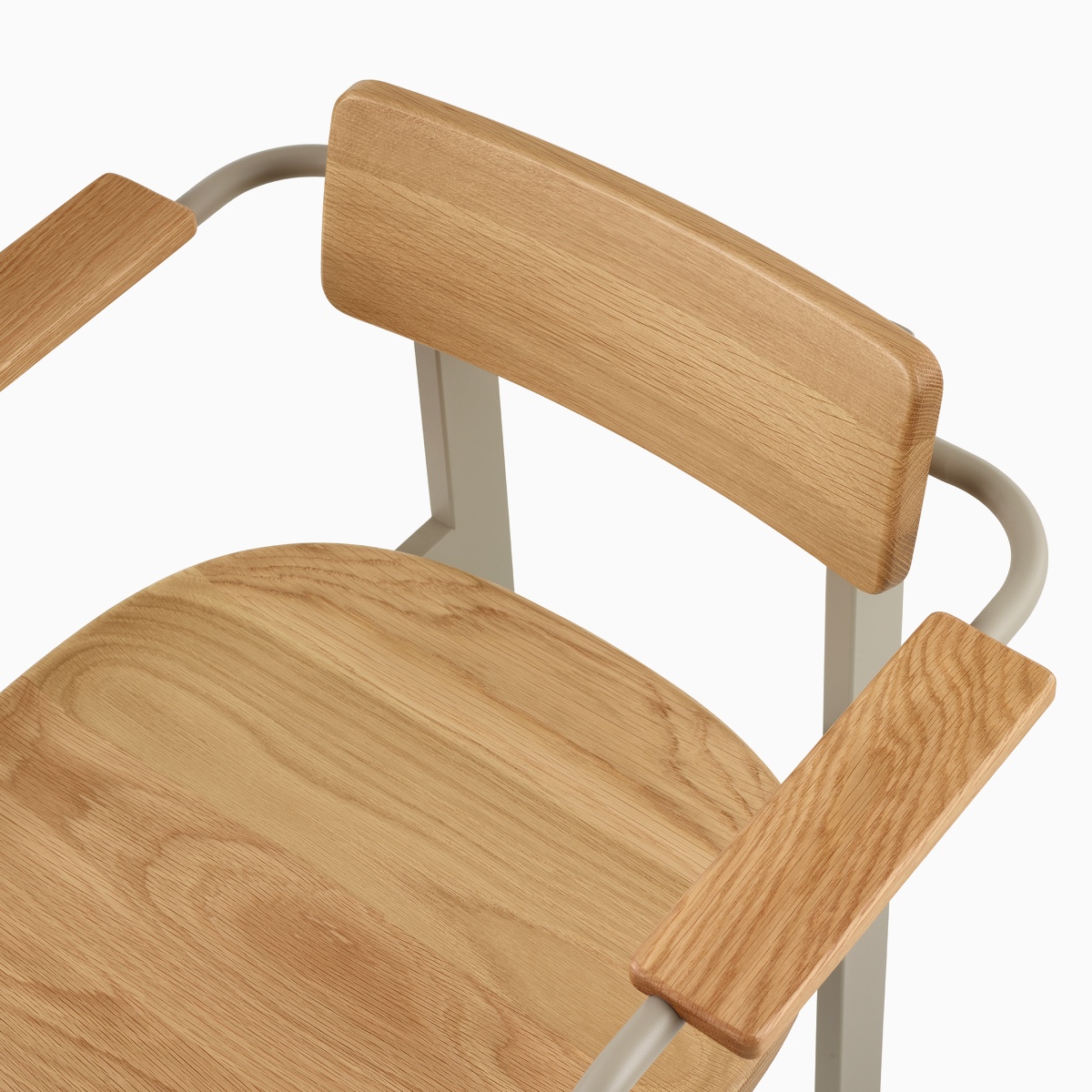 A close up of a Betwixt Chair with oak backrest, seat, and arms, with a grey frame. 