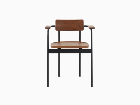 A Betwixt Chair with a walnut backrest, seat, and arms with a black frame. 