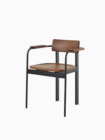 A Betwixt Chair with a walnut backrest, seat, and arms with a black frame. 