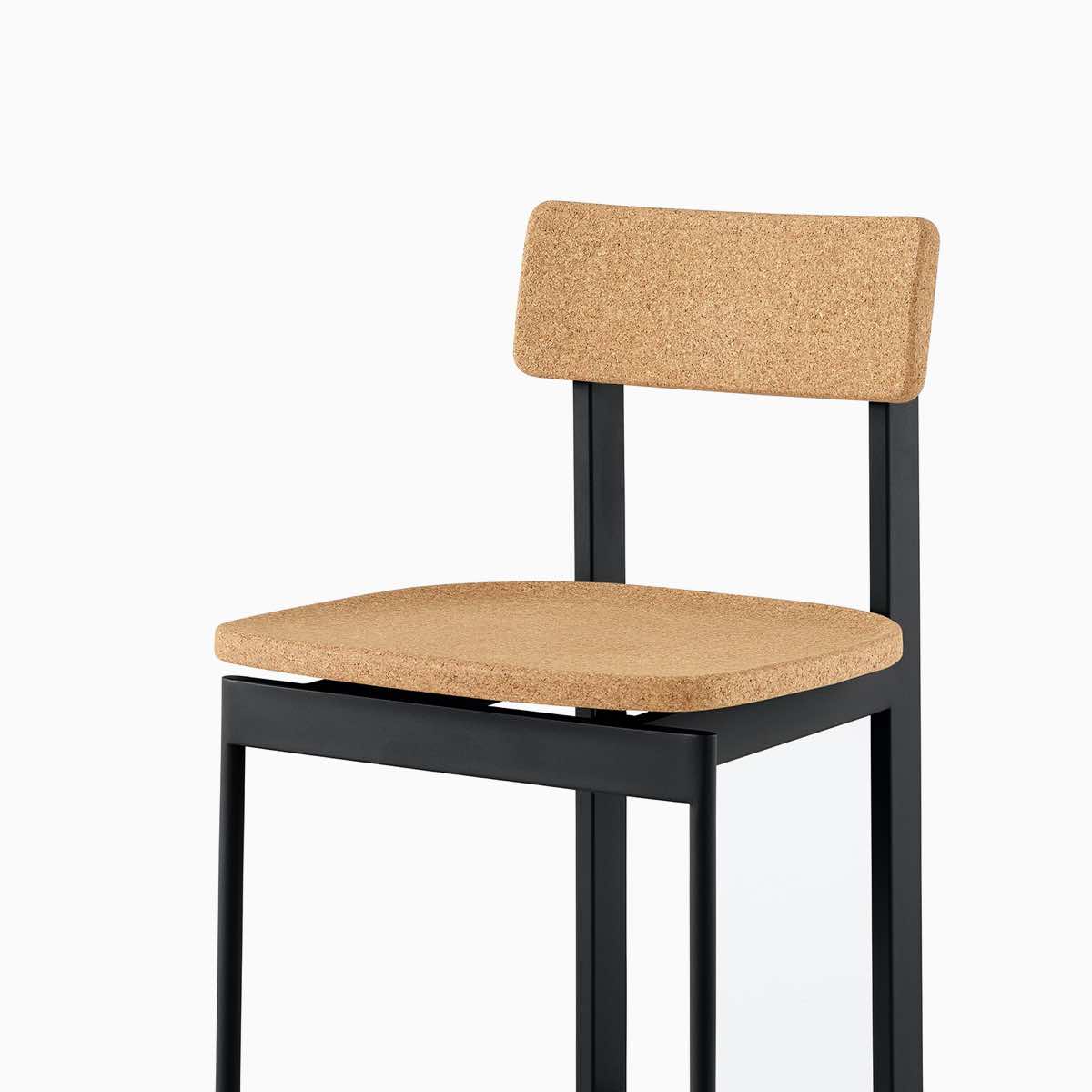 A cork Betwixt bar stool with a black frame.