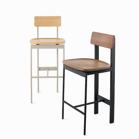 An oak Betwixt Stool next to a walnut Betwixt Stool with a black frame.