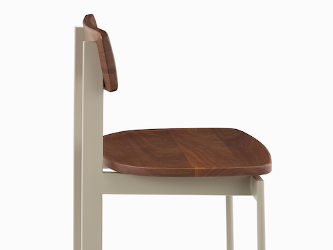 A bar-height Betwixt Stool with oak seat and backrest with a grey frame.