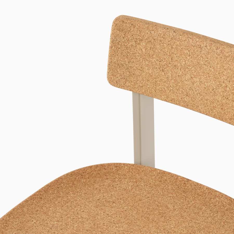 A close-up of a Betwixt Stool with a cork seat and backrest.