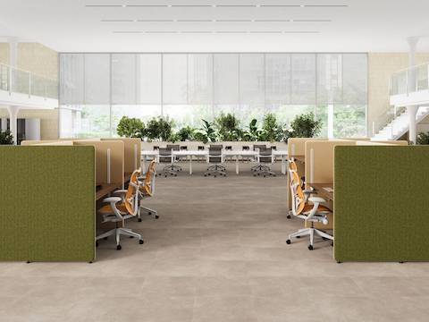 A split level open office with green and yellow Bound Sit-Stand Desking with Mirra 2 Butterfly Chairs.
