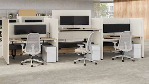 A office setting with taupe and cream Bound Sit-Stand Desking with Lino Office Chairs, with a Bound Freestanding Screen.