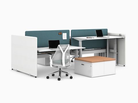 Light green and white Bound Screens mounted to a white Nevi Link workstation with four worksurfaces, white Sayl Chairs and Paragraph Storage viewed from an angle.