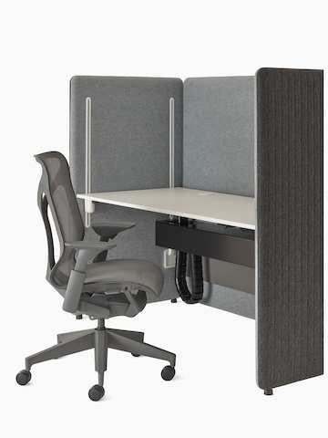 Angled view of light and dark grey Bound Sit-Stand Booth with Cosm chair.