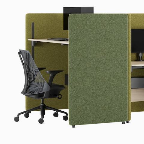 Angled view of a five‑person green back‑to‑back Bound Sit‑Stand Desking configuration with a Bound Sit‑Stand booth at one end, shown with Sayl chairs and dual monitors.