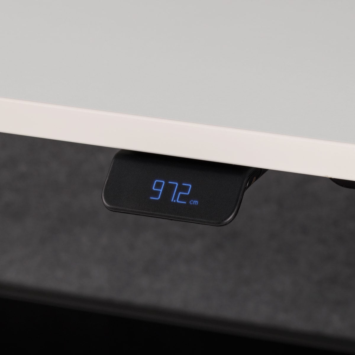 Height adjustable digital high performance handset on white worksurface.