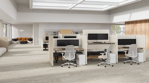 A office setting with taupe and cream Bound Sit-Stand Desking with Lino Office Chairs, with a Bound Freestanding Screen.