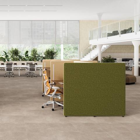 A split level open office with green and yellow Bound Sit-Stand Desking with Mirra 2 Butterfly Chairs.