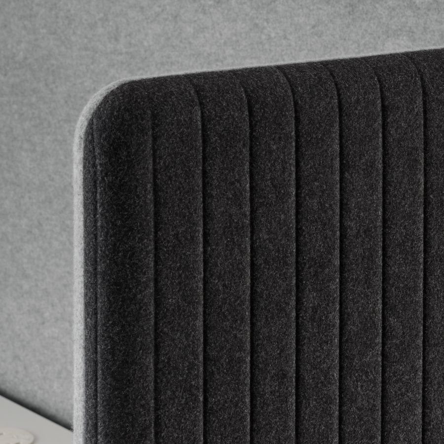 Detail of exterior panel option for Bound Sit-Stand Desking showing rounded soft fabric corner.