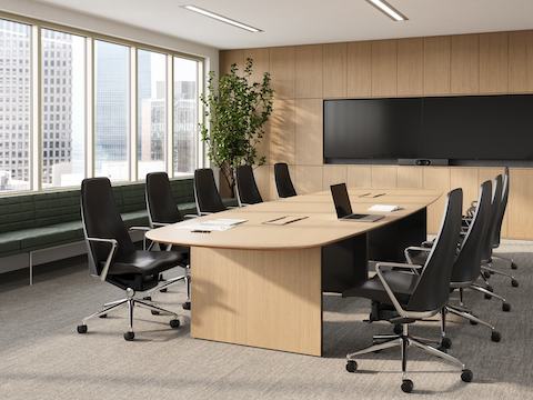 A boat shaped Byne Meeting Table with Bow legs, surrounded by Taper Chairs.