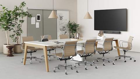 Byne System with Sylvain legs and a universal middle leg for wire entry in an 8-seat cluster, with Eames Aluminum Group Chairs.