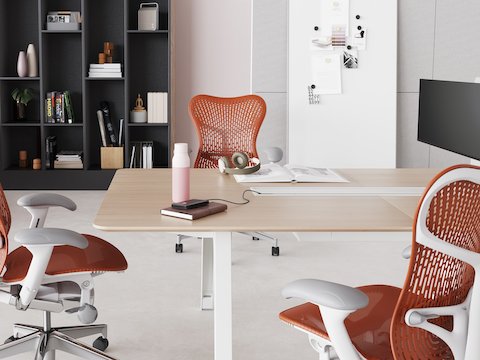 Brown and white Byne System workstations with blue and grey screens and white Sayl Chairs.