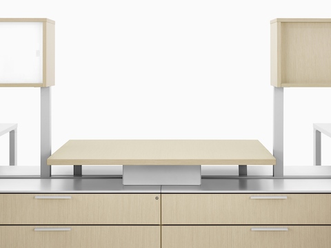 A close-up image of a Canvas Dock workstation in light wood with a central collaboration space.