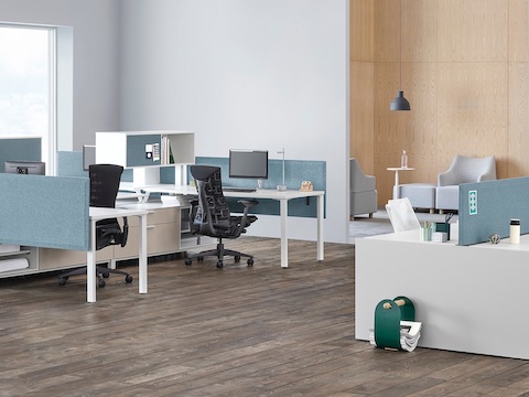 Canvas Channel and Canvas Dock workstations with blue panels, positioned near a lounge area.