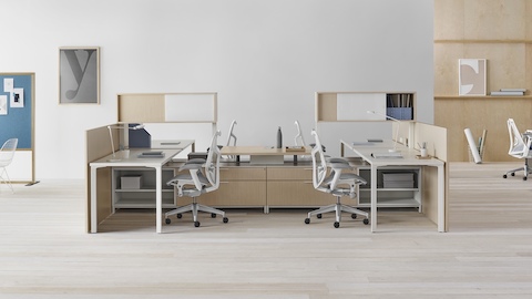 A Canvas Dock workstation in light wood and white with grey Mirra 2 office chairs.