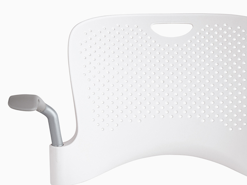 Close view of the holes in the polypropylene back of a white Caper chair. Close view of the holes in the polypropylene back of a white Caper chair.