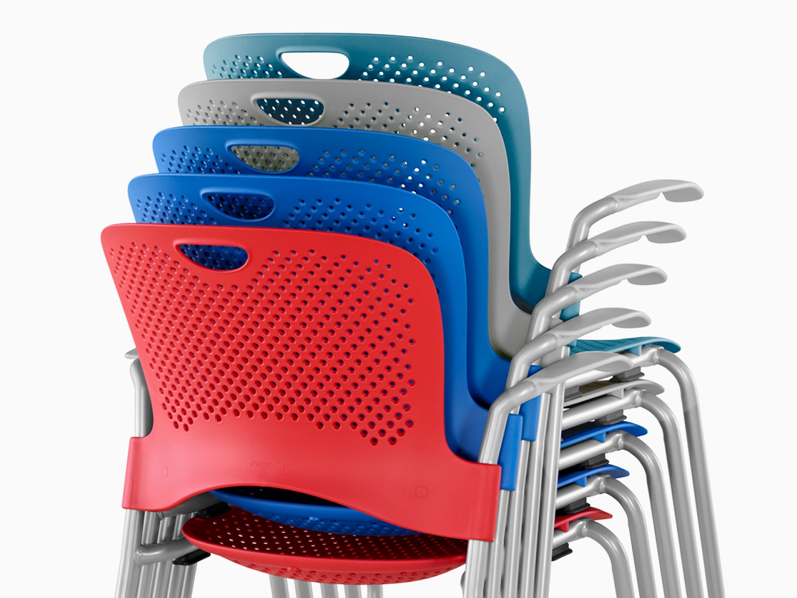 Rear view of red, blue, grey and turquoise Caper chairs, stacked five high.