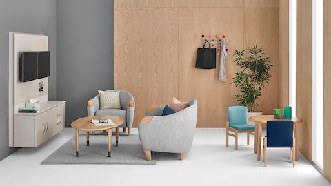 Compass modular components and gray club chairs in a healthcare lounge. Select to go to the Compass System product page.