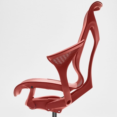 Side view of a Cosm high-back chair in dark red with leaf arms.