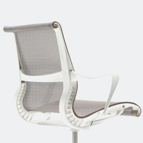 Rear-angle view of a Setu Chair with fixed arms, a studio white frame, silver alloy base, and cocoa brown suspension.