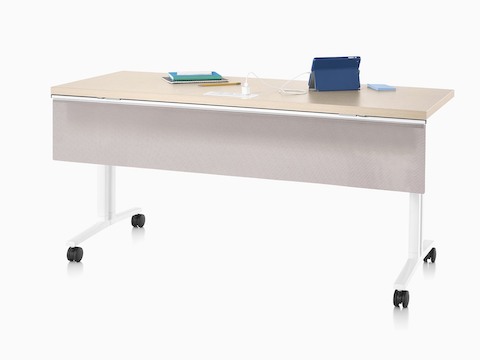 A rectangular work surface with casters and a modesty panel.