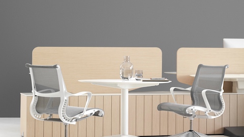 An interaction space featuring a Setu work table and chairs placed before a Locale workbase and screen.