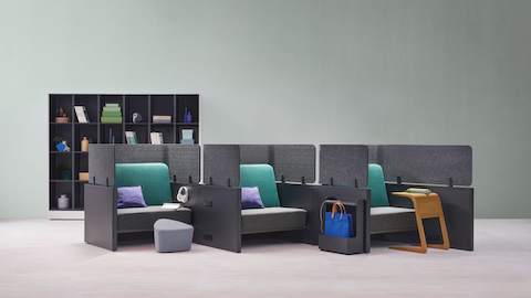 Catena Office Landscape components form three small soft seating spaces enclosed with grey privacy panels. Catena Office Landscape components form three small soft seating spaces enclosed with grey privacy panels.