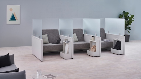 Catena Office Landscape components form three small soft seating spaces enclosed with glass screens and Ubi Mobile Bag Catch accessories.