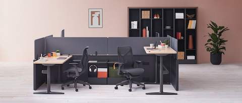Catena Office Landscape workstations with light wood surfaces and gray fabric screens, black Cosm Chairs, and Port Storage System. 