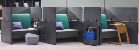 Catena Office Landscape components form three small soft seating spaces enclosed with grey privacy panels.