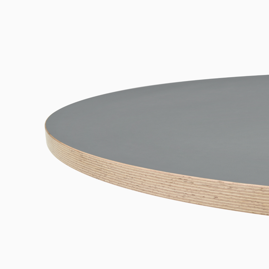 A close-up view of a grey Civic Table top with a wooden square edge.