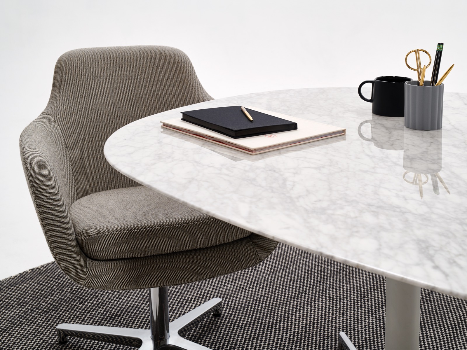 A white marble Civic Table with a gray Saiba office chair.