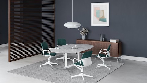 Four green and white Keyn chairs are grouped around a white marble Civic Table. A walnut screen divides the room with a standing height Civic Table positioned by a window. Four green and white Keyn chairs are grouped around a white marble Civic Table. A walnut screen divides the room with a standing height Civic Table positioned by a window.