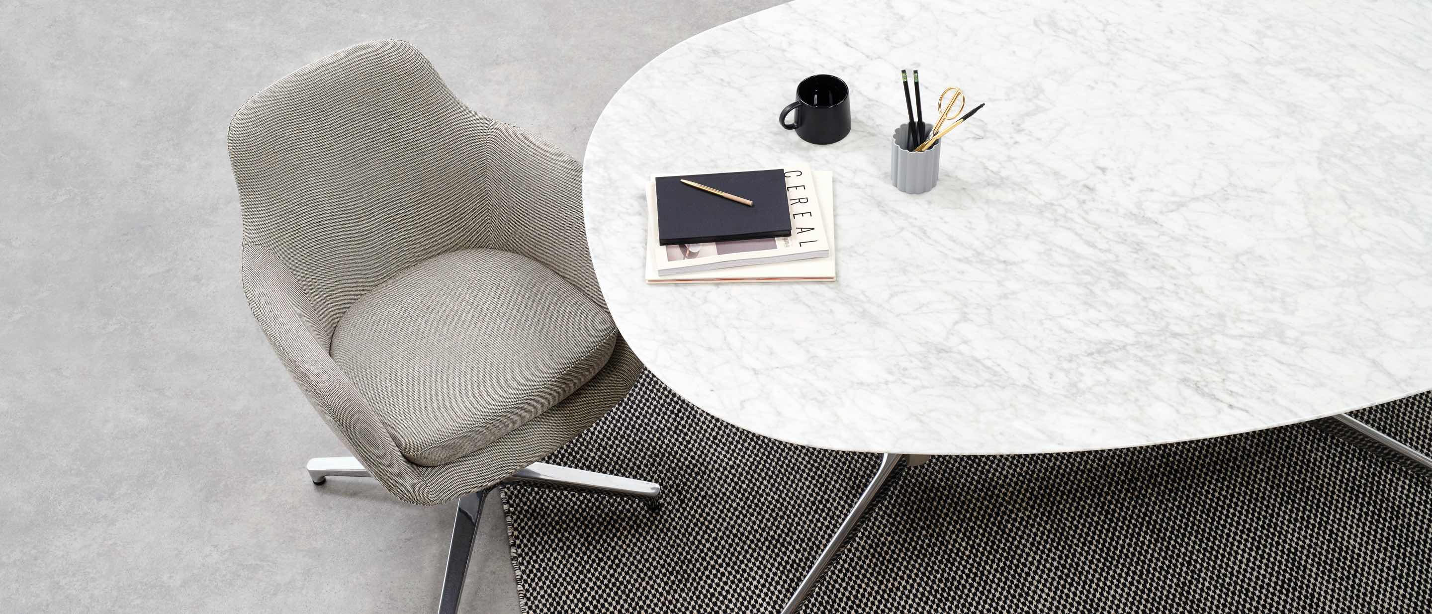 An oak top Civic Table with a grey Saiba office chair, viewed from above.