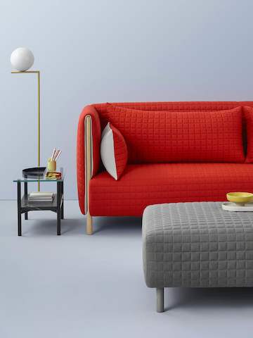 Partial views of a red ColourForm sofa and gray ColourForm ottoman.