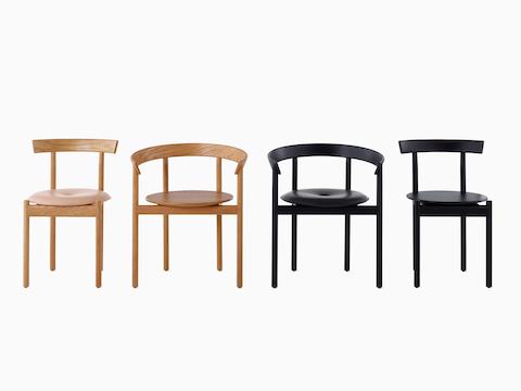 A line up of two oak Comma Chairs and two black Comma Chairs.
