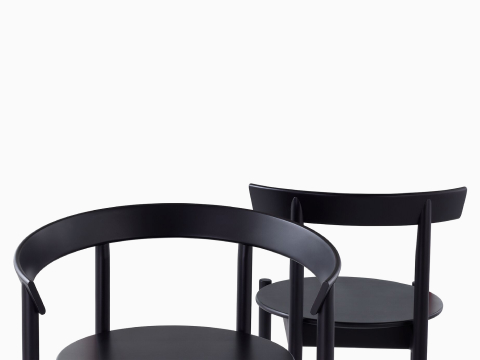 Close up view of the frames of two Comma Chairs.