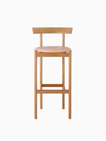 An oak bar-height Comma Stool with a seat pad, viewed from the front.