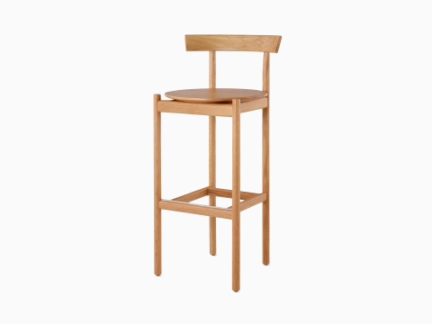 An oak bar-height Comma Stool, viewed from the front at an angle.