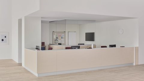 A caregiver environment with a Commend Nurses Station boundary wall and interior team zone defined by surface-to-ceiling glass.