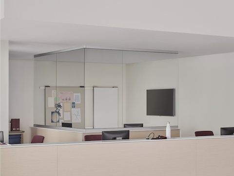 A caregiver environment with a Commend Nurses Station boundary wall and interior team zone defined by surface-to-ceiling glass.